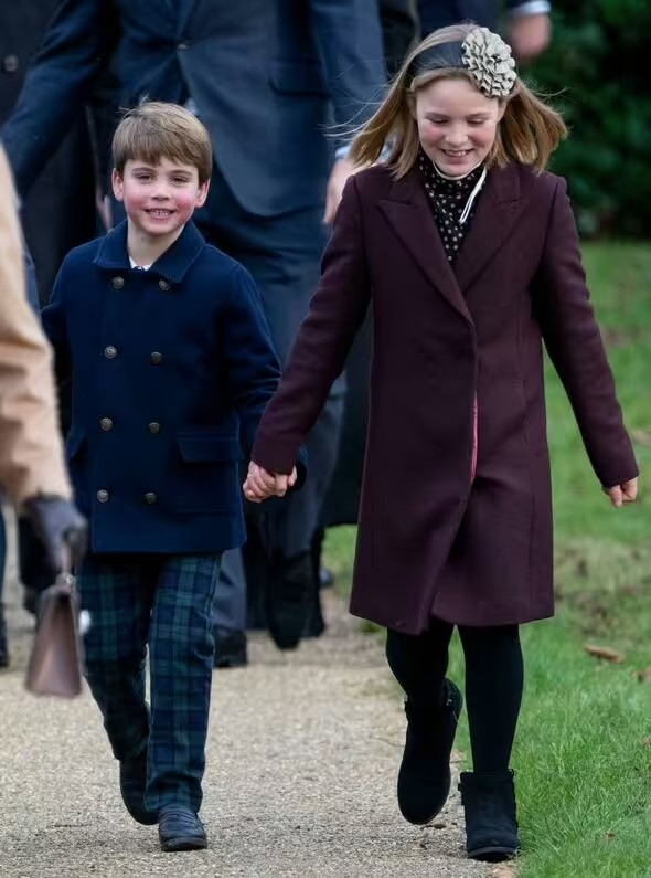Prince Louis holding hands with Zara and Mike Tindall's eldest daughter Mia (Image: UK Press via Getty Images)